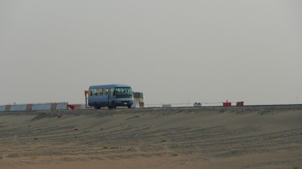 Driving an open desert road on a day trip outside Dubai