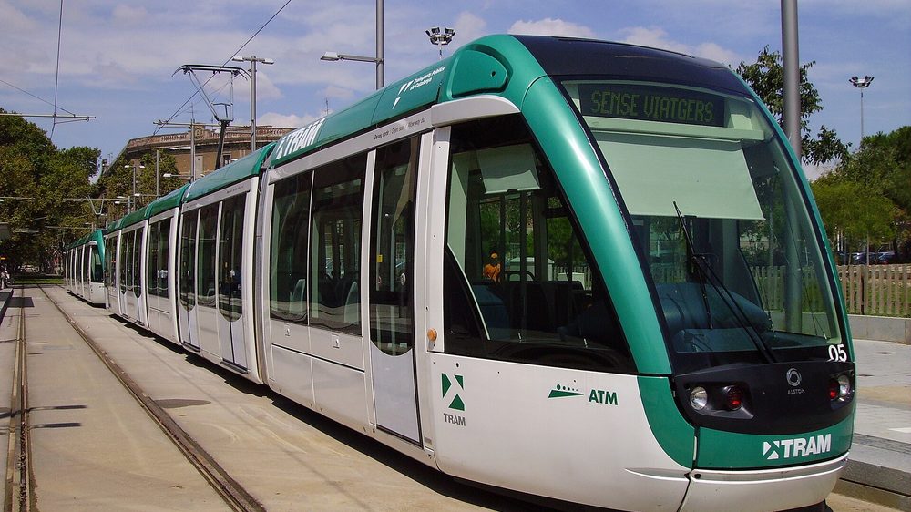 The Barcelona tram glides along the edges of the city
