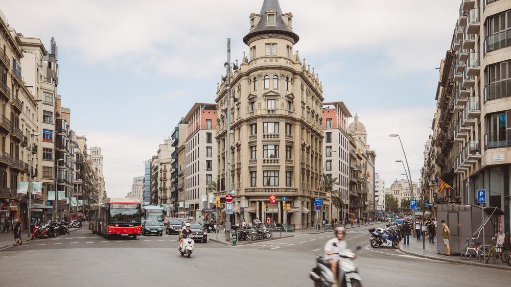 Driving a rental car through busy traffic in central Barcelona